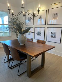 The sleek wooden dining room table paired with fake plants, a fancy chandelier, and a large black and white gallery wall of frames Dining Room Picture Wall, Hair Curtains, Thrift Store Home Decor, Hair Curtain, Bangs Curtain, Space Organization, Curtains Ideas, Bedroom Curtain, Modern Farmhouse Dining