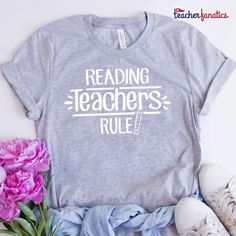 a t - shirt that reads reading teachers rules next to some pink flowers and shoes