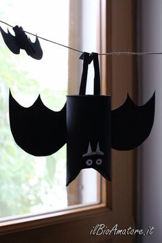 some paper bats hanging from a clothes line