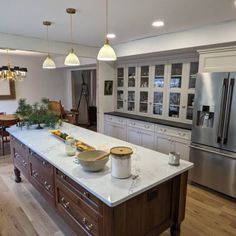 a large kitchen with an island in the middle