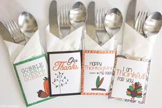 four thanksgiving cards on napkins with forks and spoons next to eachother