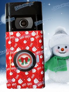 a cell phone with a snowman on it next to a christmas themed case for the phone