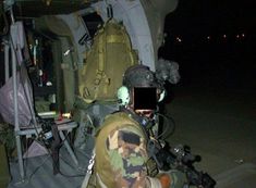 a man sitting in the back of an airplane next to another person with a camera