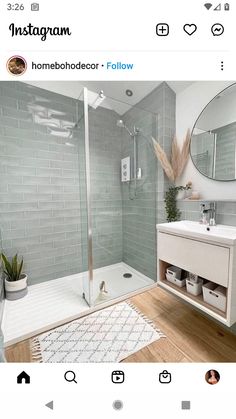 a bathroom with grey tiles and white fixtures, including a shower stall and sink area