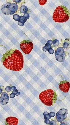 blueberries and strawberries are on a checkered tablecloth