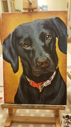 a painting of a black dog on an easel