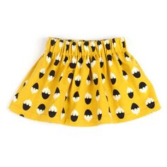 a yellow skirt with black and white polka dots on the bottom, in front of a white background