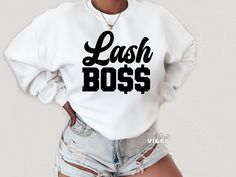 a woman wearing shorts and a white sweatshirt with the words cash boss printed on it