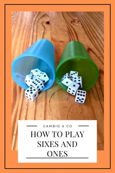 two buckets filled with dice sitting on top of a wooden table next to each other