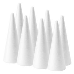 six white cones are lined up in a row on a white background, with one cone facing the camera