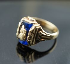 This is the perfect option for those who like cool, unique jewelry and the luxury, shine of gold, blue. This ring is well made, cute and/or elegant in design, and very desirable. Vintage ring decorated with the blue stone in the center and signed A -1955-6 The ring has a hallmark, 10k Josten. Its weight is 4.9 grams and is a size 6 3/4. In good condition. Every one interested in the jewelry should remember that he or she must like their jewelry- not just at first sight.... but for always. To hav Formal Blue Signet Ring Stamped 14k, Oval Blue Signet Ring In 14k Gold, Blue 14k Gold Ring Stamped 14k, Heirloom Sapphire Ring With Polished Finish, Blue 14k Gold Signet Ring With Gemstone, Formal Blue 14k Gold Signet Ring, Blue Oval Signet Ring Stamped 14k, Blue 14k Stamped Promise Ring, 14k Gold Sapphire Signet Ring As Gift