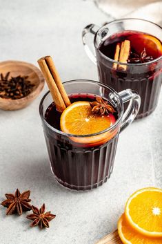 two mugs filled with mulled and spices