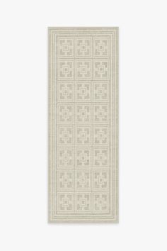 a white rug with an intricate design on the front and back side, against a white background