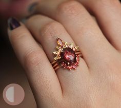 a close up of a person's hand with a ring on it