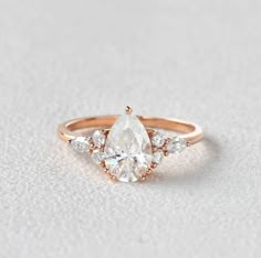 an engagement ring with three pear shaped diamonds