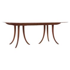 a wooden table with two curved legs