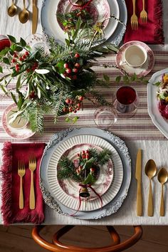 the table is set for christmas dinner with silverware