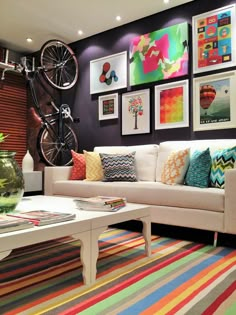 a living room filled with lots of colorful furniture and pictures on the wall above it