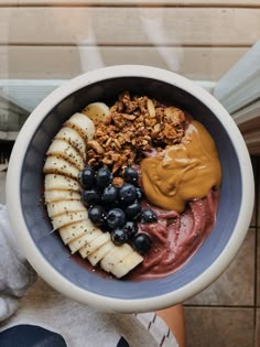 a bowl filled with fruit and nuts on top of a table