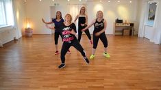 four women are dancing in a dance studio