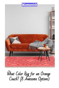 an orange couch sitting on top of a pink rug next to a table with a cup