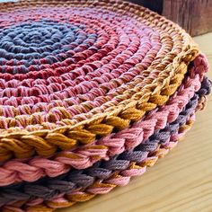 three braided baskets sitting on top of a wooden table