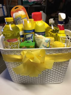 a white basket filled with lots of cleaning products