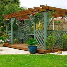 a garden area with a gazebo and potted plants