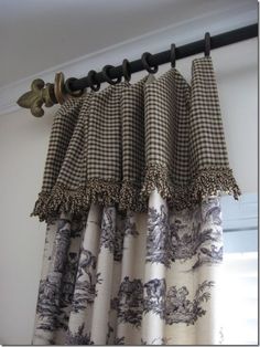 the curtains are hanging on the rod in front of the window with black and white checkered drapes