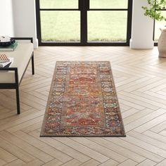 a living room with a large rug on the floor