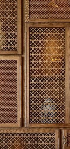 an intricately carved wooden cabinet with glass doors and lattices on the front door