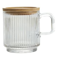 a clear glass mug with a wooden lid