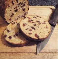 a loaf of bread sitting on top of a cutting board next to a knife