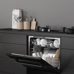 an open dishwasher in a kitchen with dishes and utensils on the counter