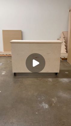 a white box sitting on top of a floor in a room filled with cardboard boxes