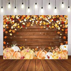 an autumn scene with pumpkins and fall leaves on the wood floor in front of a wooden wall