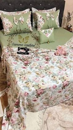 a bed with floral sheets and pillows on it