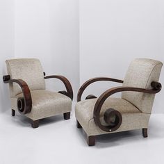 two chairs sitting next to each other on a white floor