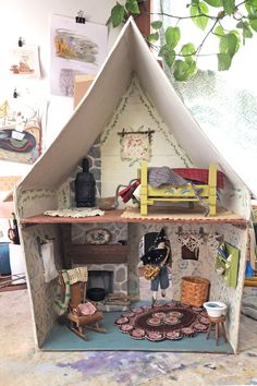 a doll house with furniture and accessories inside