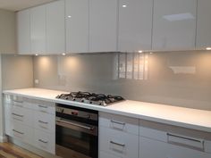 a kitchen with white cabinets and an oven