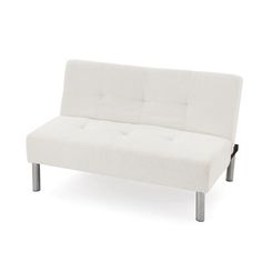 a white couch sitting on top of a metal frame