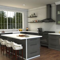 a kitchen with gray cabinets and white counter tops, along with bar stools that match the hardwood flooring