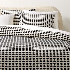 a bed with black and white polka dots on it