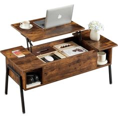 a wooden desk with a laptop on top and coffee cup in front of the table