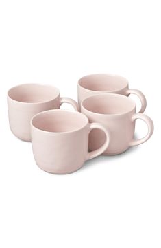 four pink coffee cups sitting next to each other