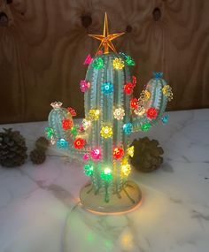 a cactus with lights on it sitting on a table