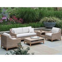 an outdoor living room with wicker furniture