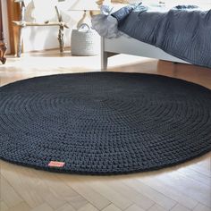 a round rug on the floor in a bedroom