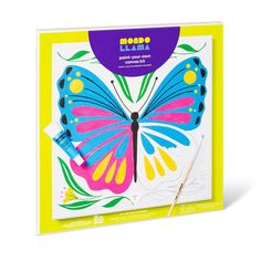 an image of a colorful butterfly on the back of a book with markers and pencils