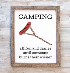 a wooden frame with a sign that says camping all fun and games until someone burns their wiener